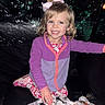 Ophelia is registered to the contest to win money with this photo: child, girl, smile, bow, pajamas, blanket, cat_pattern, purple_jacket, indoor, happy, blue_eyes, cute, cozy, sitting, clothing, footwear, face, hair, portrait, childhood