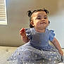 Angelina joined the competition — help win amazing prizes! baby, blue, child, curly_hair, cushion, cute, dress, gold_jewelry, happy, indoor, necklace, pigtails, portrait, sitting, smile, soft_lighting, sparkle, toddler, window, young_child