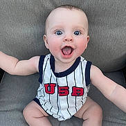 Brody joined the competition — help win amazing prizes! baby, child, smiling, happy, onesie, usa, blue_eyes, sitting, cute, infant, portrait, clothing, skin, face, expression, indoor, person, casual, seat, fabric