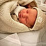 newborn, baby, sleeping, knit_hat, blanket, cozy, soft, infant, closeup, portrait, child, wrapped, cute, peaceful, indoor, bed, skin, headwear, resting, sleep