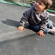 Valentino joined the competition — help win amazing prizes! casual, child, curious, cute, daylight, grass, hoodie, jeans, netting, outdoor, playing, portrait, shadow, sitting, socks, sunlight, toddler, trampoline, trees, young