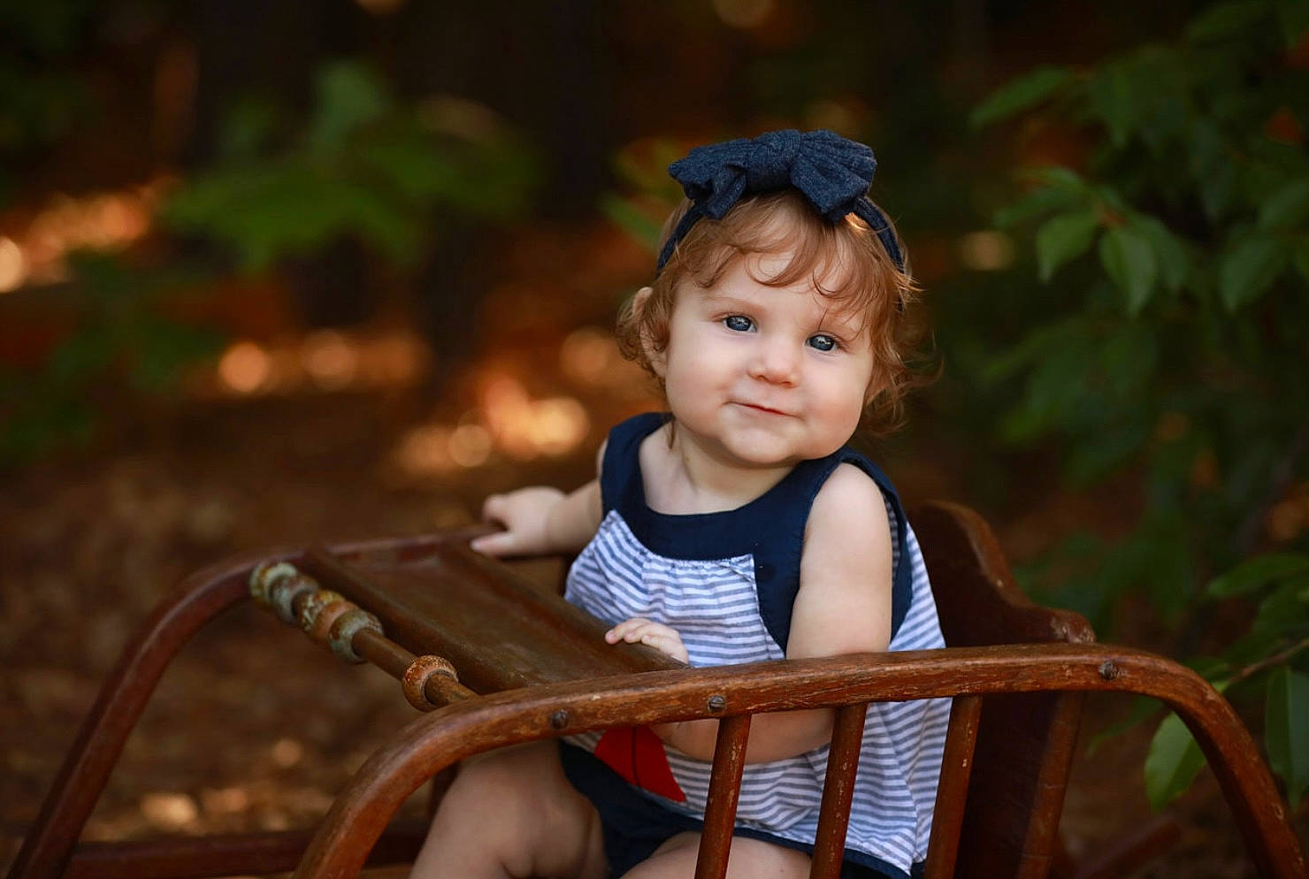 Peyton is registered to the contest to win money with this photo: baby_toddler_clothing, blond, brown_hair, chair, child, eye, flash_photography, fun, grass, hair, happy, iris, joy, leaf, leisure, people_in_nature, person, plant, sitting, skin