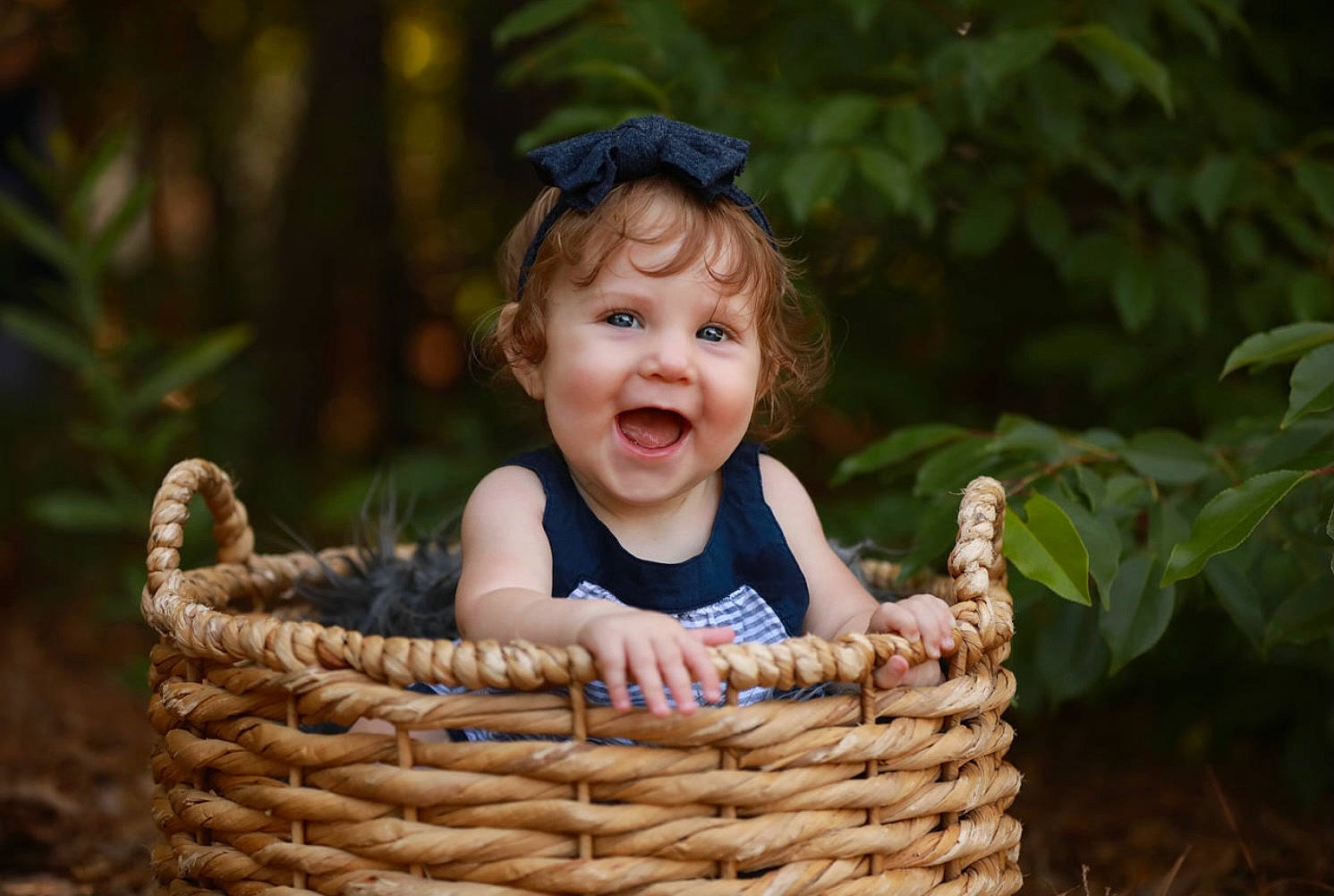 Peyton is registered to the contest to win money with this photo: baby, baby_toddler_clothing, basket, child, fun, grass, happy, hat, laugh, leisure, mammal, people_in_nature, person, picnic_basket, plant, sitting, smile, storage_basket, toddler, wicker