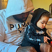 Kingston joined the competition — help win amazing prizes! beard, black_clothing, bonding, casual, child, curly_hair, curtains, family, focused, hand, hoodie, indoor, living_room, man, portrait, seated, shoe, tattoo, tying_shoe, white_clothing