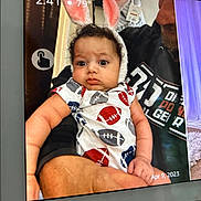 Kingston joined the competition — help win amazing prizes! baby, child, bunny_ears, onesie, football_pattern, curly_hair, tablet_screen, adult, holding, indoor, temperature_display, time_display, date_display, puzzled_expression, cute, portrait, human, hand, clothing, face