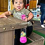 Kingston joined the competition — help win amazing prizes! toddler, child, indoor, play_area, toy, wooden_bench, curly_hair, tongue_out, green_tshirt, colorful_balls, people, carpet, play_kitchen, casual_clothing, hand, smiling, person, furniture, room, playful