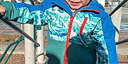 Kingston is registered to the contest to win money with this photo: blue_sky, casual_clothing, child, climbing, curly_hair, daylight, fun, handrail, happy, houses, jacket, kid, outdoor, park, person, playground, recreation, smiling, stairs, young