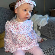 Autumn joined the competition — help win amazing prizes! toddler, child, girl, headband, floral_pattern, long_sleeves, pink_clothing, leggings, sitting, couch, indoor, soft_lighting, portrait, cute, young_child, face, expression, home, blurry_background, cozy