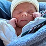 Noah is registered to the contest to win money with this photo: newborn, baby, sleeping, infant, face, portrait, knit_hat, blanket, bundled, white_clothing, cozy, peaceful, closed_eyes, fists, indoors, seated, car_seat, textile, photograph, smartphone_screen