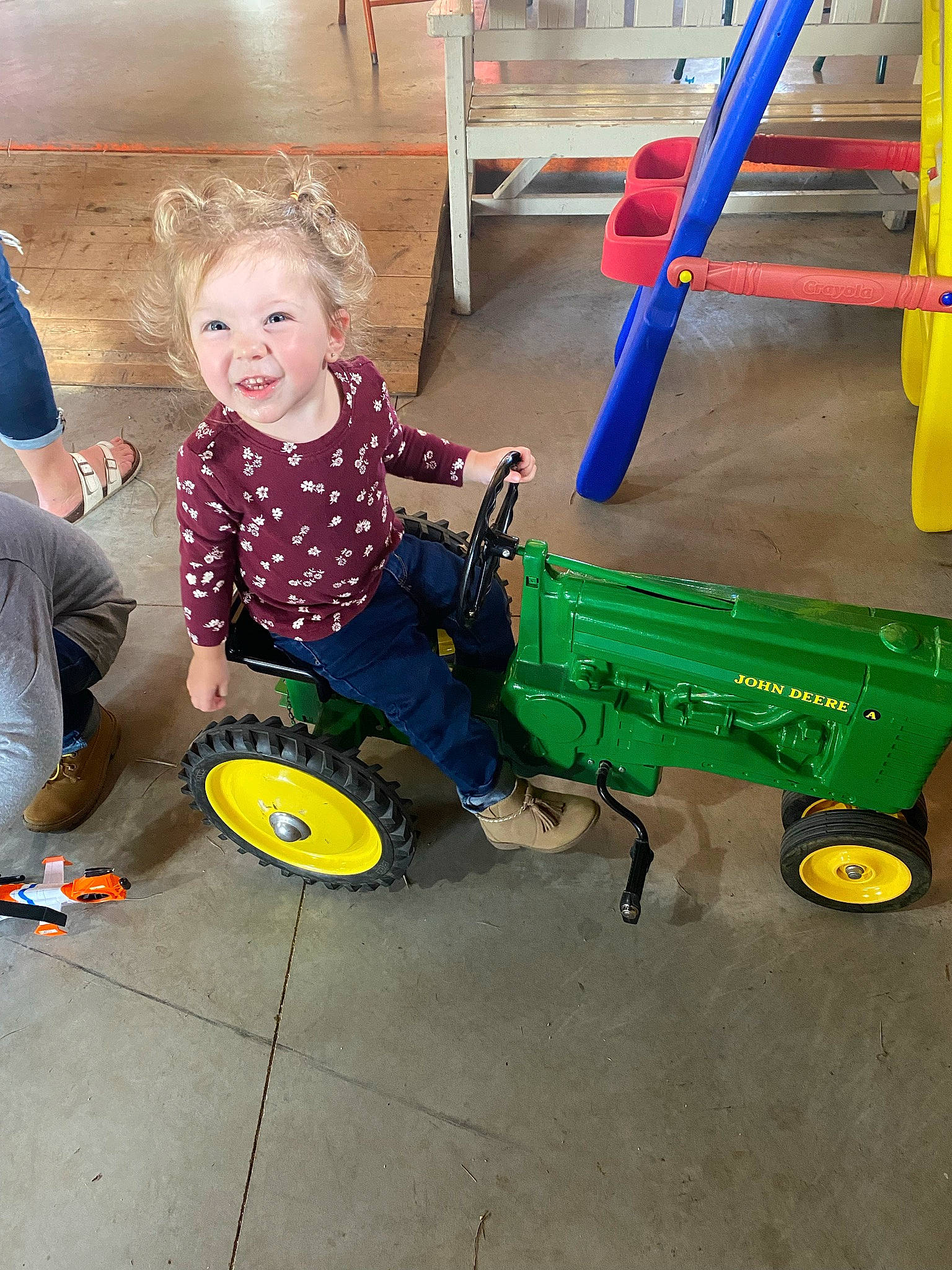 Addilyn is registered to the contest to win money with this photo: asphalt, automotive_tire, automotive_wheel_system, flooring, fun, joy, ladder, leisure, machine, outdoor_play_equipment, person, personal_protective_equipment, pipe, play, recreation, smile, t_shirt, tire, toddler, toy