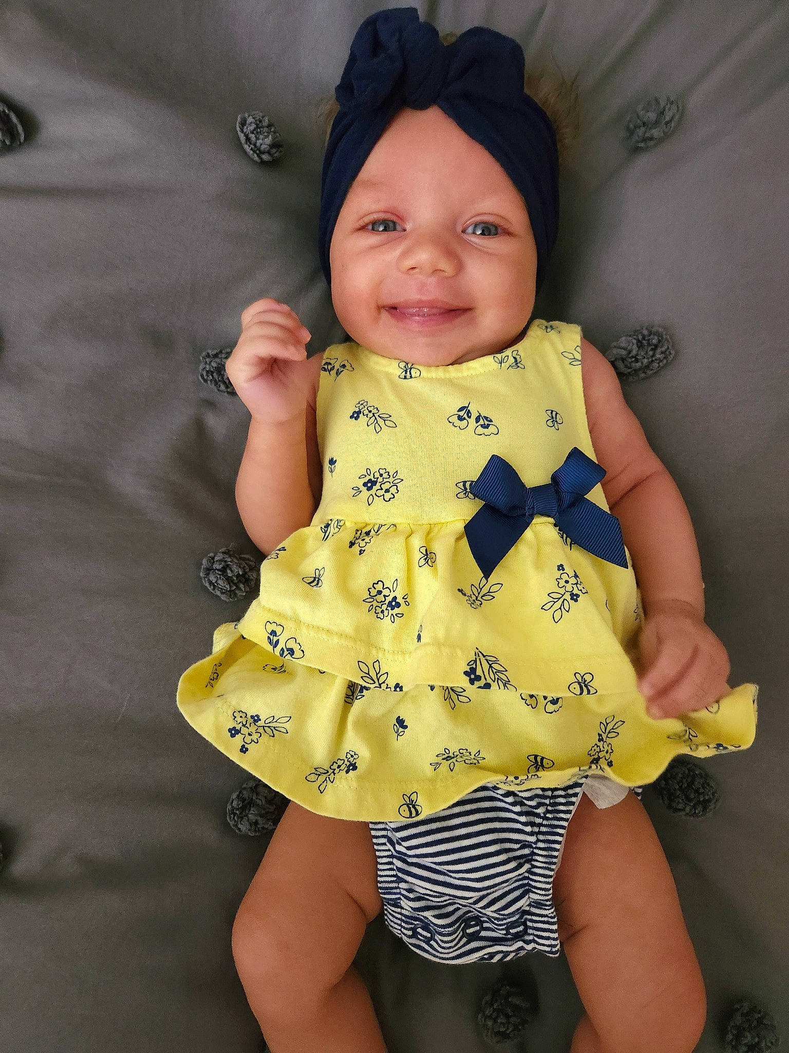 Kaisyn is registered to the contest to win money with this photo: baby, baby_toddler_clothing, child, collar, day_dress, dress, face, happy, headwear, joy, one_piece_garment, outerwear, pattern, person, product, skin, sleeve, smile, t_shirt, textile