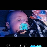 Kurvin Tanner is registered to the contest to win money with this photo: baby, pacifier, blanket, sleeping, infant, face, head, blue, heart_emoji, text_overlay, cozy, resting, child, portrait, cute, closeup, indoor, blanket_pattern, comfort, peaceful