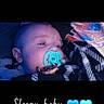baby, pacifier, blanket, sleeping, infant, face, head, blue, heart_emoji, text_overlay, cozy, resting, child, portrait, cute, closeup, indoor, blanket_pattern, comfort, peaceful