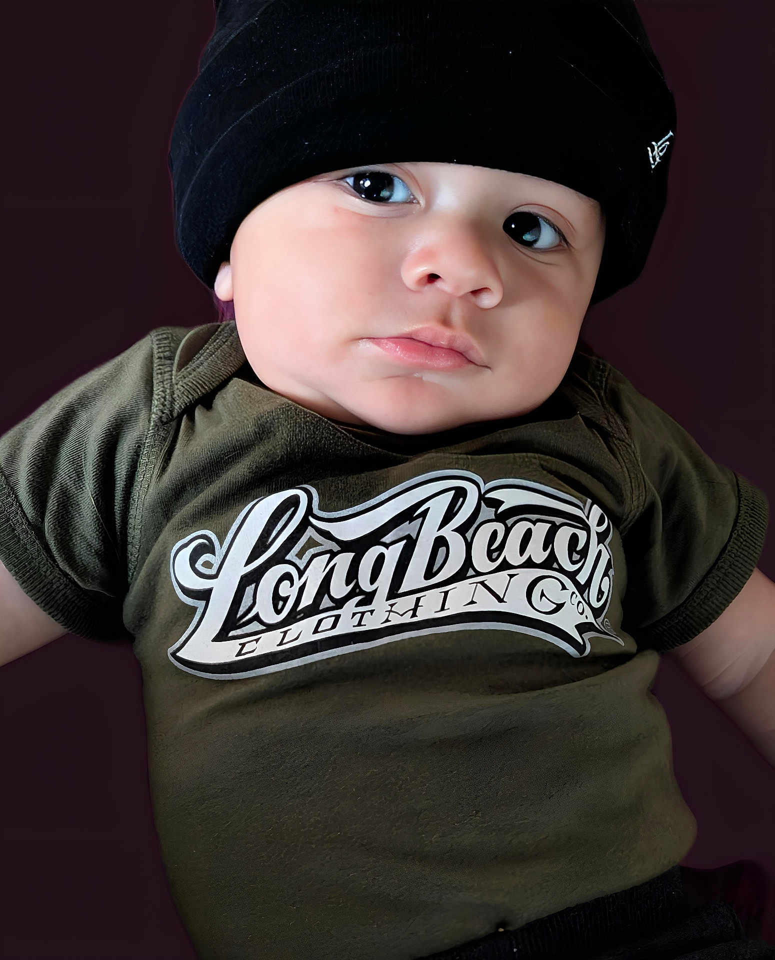 Zamir joined the competition — help win amazing prizes! baby, beanie, black, casual, child, chubby_cheeks, closeup, clothing, cute, expression, face, green, headwear, indoor, infant, person, portrait, skin, tshirt, young