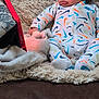 baby, blanket, casual, child, colorful, comfortable, couch, focused, indoor, infant, nike, onesie, pattern, plush, relaxed, soft, tablet, technology, watching, young