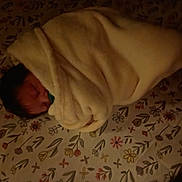 Rumi joined the competition — help win amazing prizes! newborn, baby, sleeping, swaddled, blanket, floral, bedspread, bed, portrait, face, closed_eyes, indoors, cozy, resting, infant, textile, pattern, warm_lighting, peaceful, nap