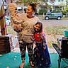 Paityn joined the competition — help win amazing prizes! woman, toddler, child, costume, pink, princess_dress, stars, porch, autumn, leaves, residential_area, car, green_carpet, purple_garland, smiling, family, holding, outdoor, casual_clothing, footwear