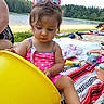 toddler, child, pink_sunglasses, yellow_bucket, swimsuit, beach, lake, trees, blanket, toy, summer, outdoor, grass, water, play, nature, sunny, person, vacation, family