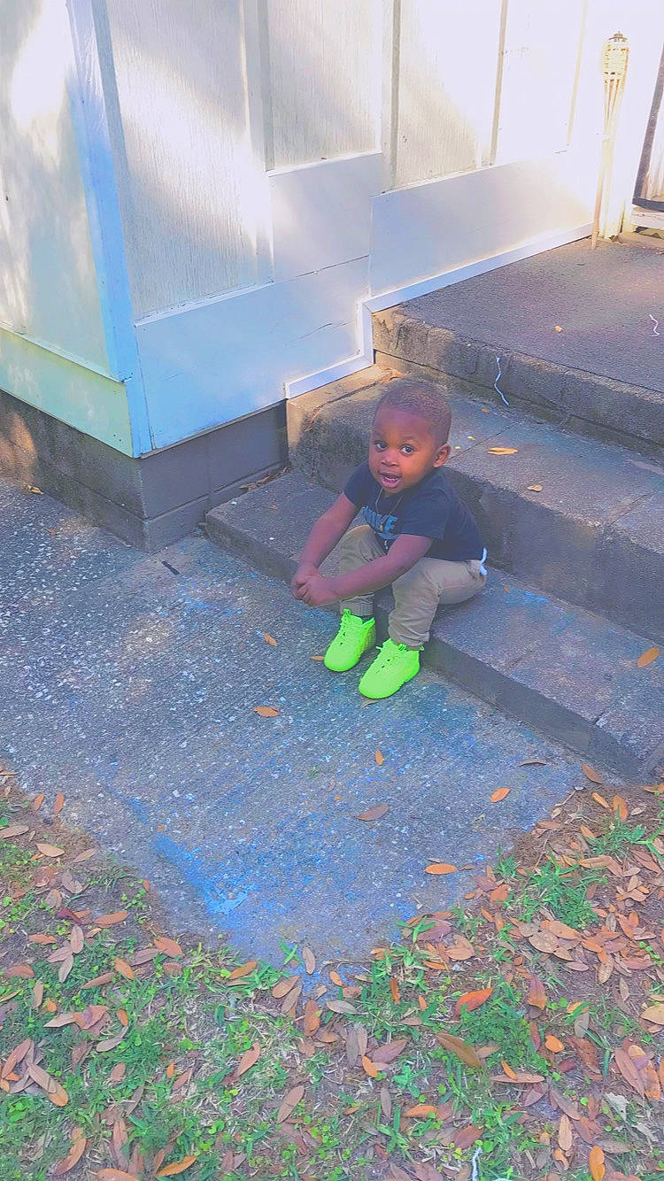 Braylon is registered to the contest to win money with this photo: asphalt, child, city, cobblestone, concrete, deciduous, electric_blue, flooring, grass, landscape, people_in_nature, person, play, road_surface, shadow, sidewalk, sitting, soil, street, tints_and_shades