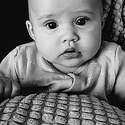Margot-Nevaeh is registered to the contest to win money with this photo: baby, black_and_white, close_up, portrait, infant, face, eyes, blanket, texture, clothing, curious, expression, head, young_child, indoors, soft_light, monochrome, sitting, person, cute