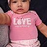 baby, infant, pink_clothing, headband, bow, cute, portrait, child, sitting, looking_at_camera, soft_background, indoor, happy, smiling, person, young_child, closeup, adorable, casual_wear, toddler