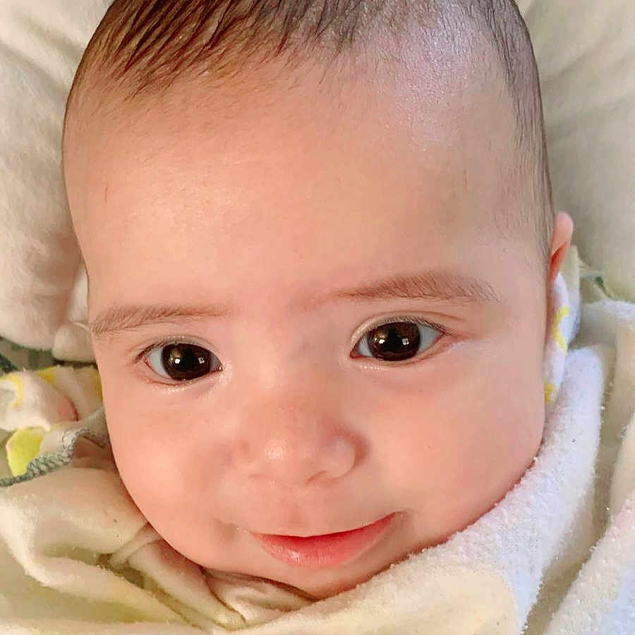 Maria Lucia joined the competition — help win amazing prizes! adorable, baby, blanket, child, closeup, comfort, cute, expression, eyes, face, head, indoors, infant, portrait, skin, sleepwear, smile, soft, warm, young