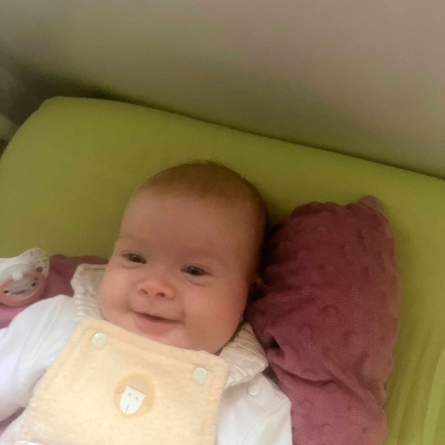 Solea participe au concours pour gagner de l'argent avec cette photo : baby, bed, blanket, child, clothing, comfort, cozy, cute, face, head, indoors, infant, pacifier, person, pillow, resting, sleeping_area, smile, soft_texture, young