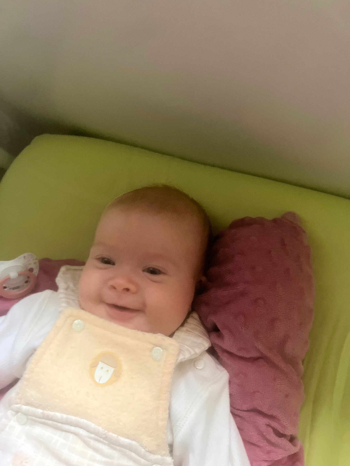 Solea participe au concours pour gagner de l'argent avec cette photo : baby, bed, blanket, child, clothing, comfort, cozy, cute, face, head, indoors, infant, pacifier, person, pillow, resting, sleeping_area, smile, soft_texture, young