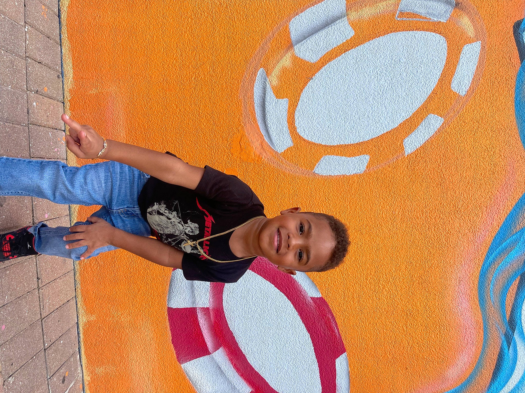 Kaden is registered to the contest to win money with this photo: art, blue, circle, concrete, cool, electric_blue, floor, flooring, font, fun, happy, joy, landscape, leisure, mural, orange, pattern, person, play, recreation