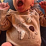 Elijah joined the competition — help win amazing prizes! baby, casual, clothing, cute, dog_design, hands, indoor, infant, jeans, lap, legs, natural_light, newborn, onesie, person, portrait, relaxed, ripped_jeans, skin, yawning