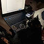 Bob is registered to the contest to win money with this photo: animal, black_and_white_cat, cat, closeup, computer, cozy, dark, digital_device, electronics, feline, home, indoor, keyboard, laptop, monitor, pet, resting, screen, sticker, technology