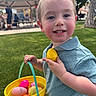 Conrad joined the competition — help win amazing prizes! child, boy, easter_egg, yellow_bucket, grass, outdoor, smile, blue_shirt, toy, park, picnic_shelter, daylight, happy, holding, colorful, basket, playing, casual_clothing, face, person