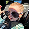 toddler, child, sunglasses, car_seat, seatbelt, striped_clothing, baby, sunlight, shadow, indoor, car_interior, cute, portrait, person, young_child, seat, casual, expression, head, face