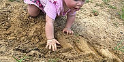 Iryis joined the competition — help win amazing prizes! toddler, child, dirt, mud, outdoor, grass, boots, legs, pink_clothing, exploring, nature, crawling, grass_field, summer, play, hands, young_child, casual_wear, curious, adventure