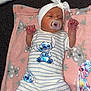 Maeve is registered to the contest to win money with this photo: baby, infant, pacifier, headband, bow, striped_onesie, stitch_character, pink_blanket, koala_pattern, carpet, sleeping, cute, newborn, soft_texture, clothing, child, lying_down, indoors, comfort, adorable