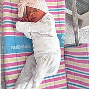 Maeve joined the competition — help win amazing prizes! newborn, baby, sleeping, hat, bow, blanket, striped, hospital, bassinet, infant, clothing, cute, peaceful, resting, child, person, soft, tiny, wrapped, cozy