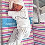 newborn, baby, sleeping, hat, bow, blanket, striped, hospital, bassinet, infant, clothing, cute, peaceful, resting, child, person, soft, tiny, wrapped, cozy