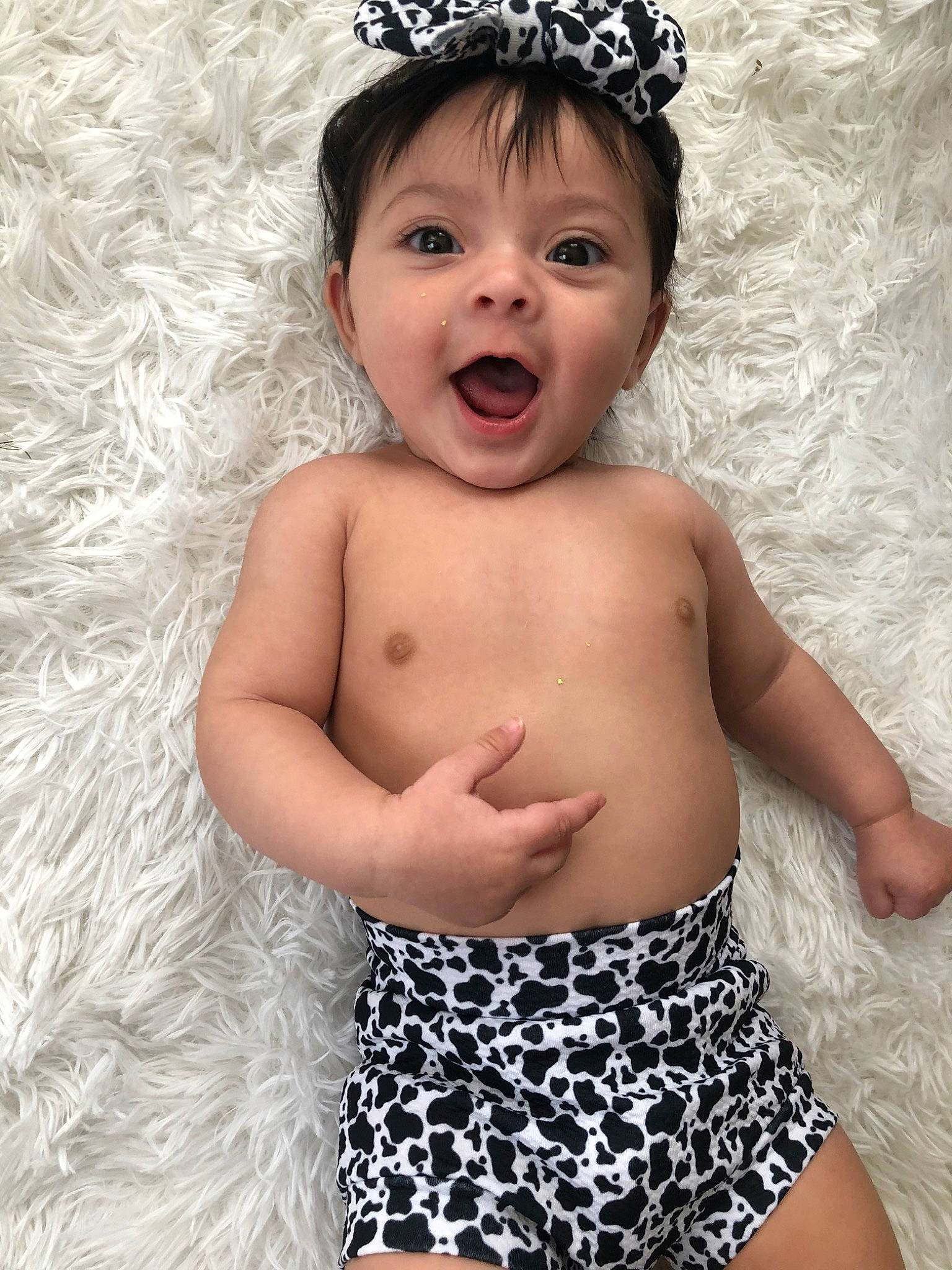 Aiyana is registered to the contest to win money with this photo: abdomen, baby, baby_bloomers, baby_toddler_clothing, chest, child, child_model, clothing, costume_accessory, fashion_accessory, hair_accessory, headband, headgear, headpiece, muscle, person, photography, product, smile, surprise