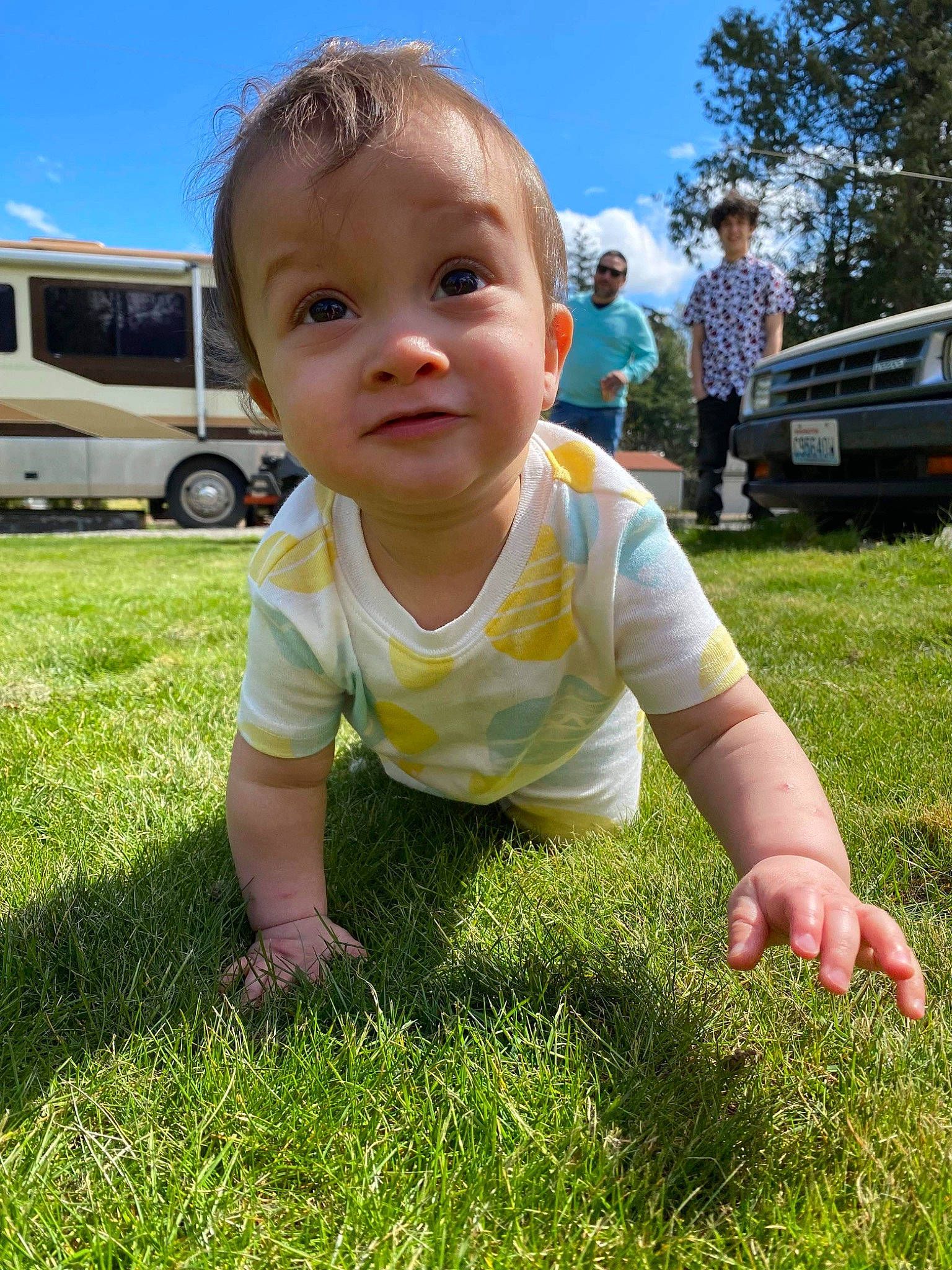 Kyrie is registered to the contest to win money with this photo: baby, baby_toddler_clothing, car, face, finger, grass, happy, head, joy, leaf, mammal, people_in_nature, person, plant, sky, smile, summer, tire, toddler, vehicle