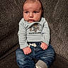 baby, child, infant, sitting, clothing, jeans, sock, couch, fabric, face, portrait, hand, furniture, cute, expression, indoor, person, top, new_to_the_crew, casual