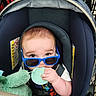 baby, blue_sunglasses, car_seat, child, toy, hand, stroller, infant, cute, chewing, seatbelt, fabric, closeup, indoor, child_seat, soft_toy, grip, young_child, casual, portrait
