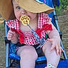baby, child, pacifier, hat, stroller, outdoor, summer, red_bow, checkered_clothing, sandal, cute, infant, sunhat, blue_stroller, grass, legs, hand, footwear, nature, portrait