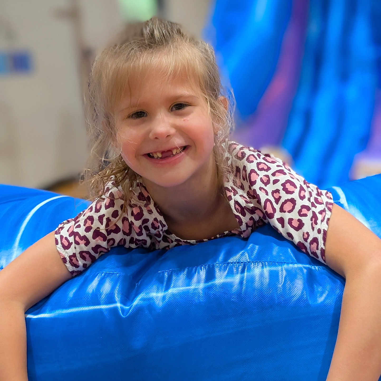 Dusty joined the competition — help win amazing prizes! arms, blonde_hair, blue, candid, casual, child, cute, face, fun, girl, happy, indoor, inflatable, leopard_print, person, playful, portrait, shirt, smile, young