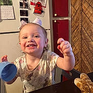Oaklynn joined the competition — help win amazing prizes! biohazard_sign, bow, cabinet, casual, chair, child, cup, happy, indoor, kitchen, person, playful, portrait, refrigerator, smiling, table, toddler, toy, ultrasound_pictures, wood_paneling