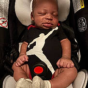 Robert is registered to the contest to win money with this photo: baby, infant, car_seat, onesie, sleeping, child, socks, safety, rest, cute, straps, padding, newborn, portrait, peaceful, clothing, babywear, head_support, indoor, seatbelt