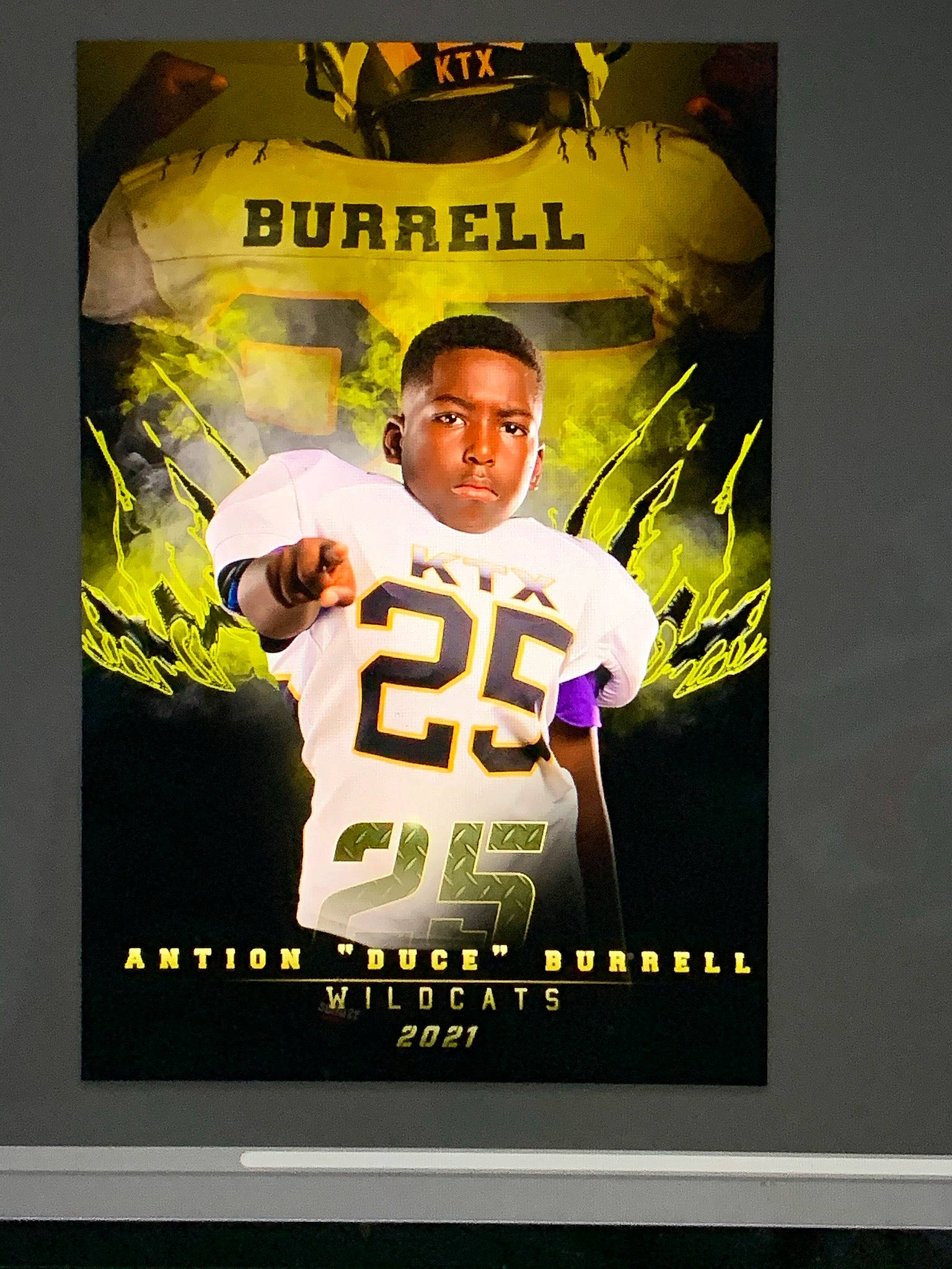 Antion is registered to the contest to win money with this photo: advertising, ball_game, competition_event, display_device, font, graphics, jersey, logo, person, player, poster, sleeve, sports_collectible, sports_gear, sports_jersey, sports_uniform, sportswear, super_bowl, t_shirt, team_sport