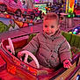 Milana a rejoint le concours — aidez-le/la à gagner de superbes lots ! toddler, child, amusement_park, bumper_car, ride, striped_jacket, pigtails, smiling, indoor, colorful, lights, fun, entertainment, playful, vehicle, people, background, family_outing, happy, casual_clothing
