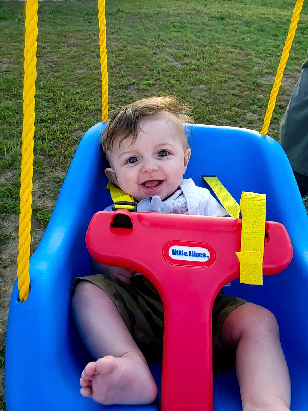 Kolson is registered to the contest to win money with this photo: baby_products, child, fun, leisure, outdoor_play_equipment, person, play, playground, product, public_space, recreation, swing, toddler, yellow