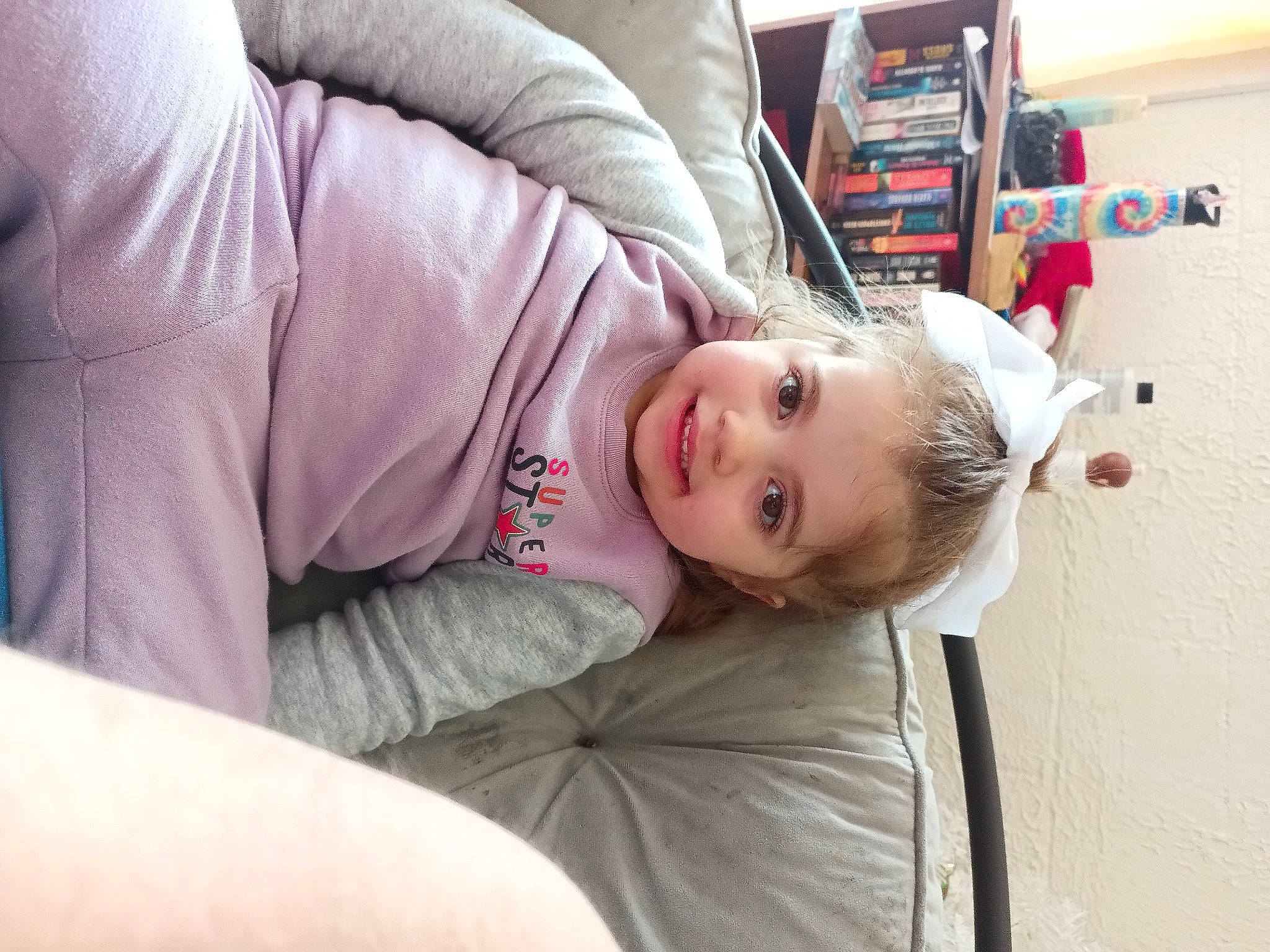 Kenzlie is registered to the contest to win money with this photo: child, comfort, couch, elbow, flooring, fun, fur, joy, person, room, shoulder, sitting, skin, sleeve, toddler, wood