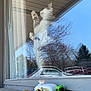 cat, window, reflection, toy_car, toy_truck, glass, outdoor, trees, car, sill, animal, pet, feline, daylight, nature_reflection, playful, cute, paws, vehicle, colorful